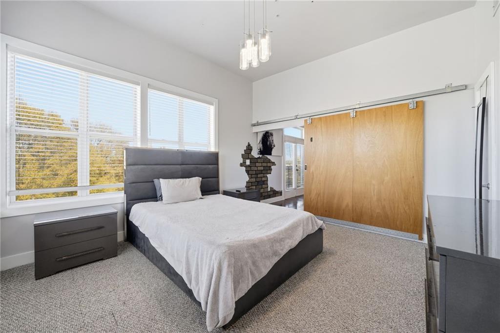 502 Pryor Street Southwest, Unit 328 Atlanta, GA 30312 - Photo 20 of 46 a bedroom with a bed dresser and a window