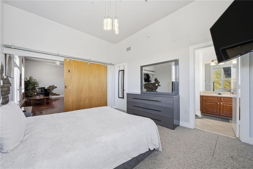 502 Pryor Street Southwest, Unit 328 Atlanta, GA 30312 - Photo 21 of 46 a bedroom with a bed and a flat screen tv