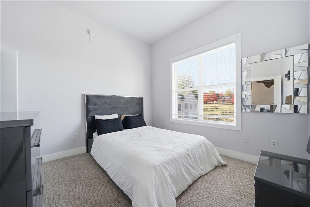 502 Pryor Street Southwest, Unit 328 Atlanta, GA 30312 - Photo 25 of 46 a bed sitting in a bedroom next to a window