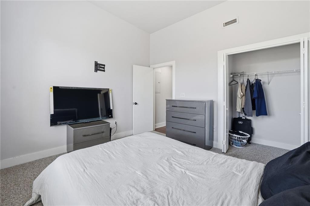 502 Pryor Street Southwest, Unit 328 Atlanta, GA 30312 - Photo 26 of 46 a bedroom with a bed and a flat screen tv