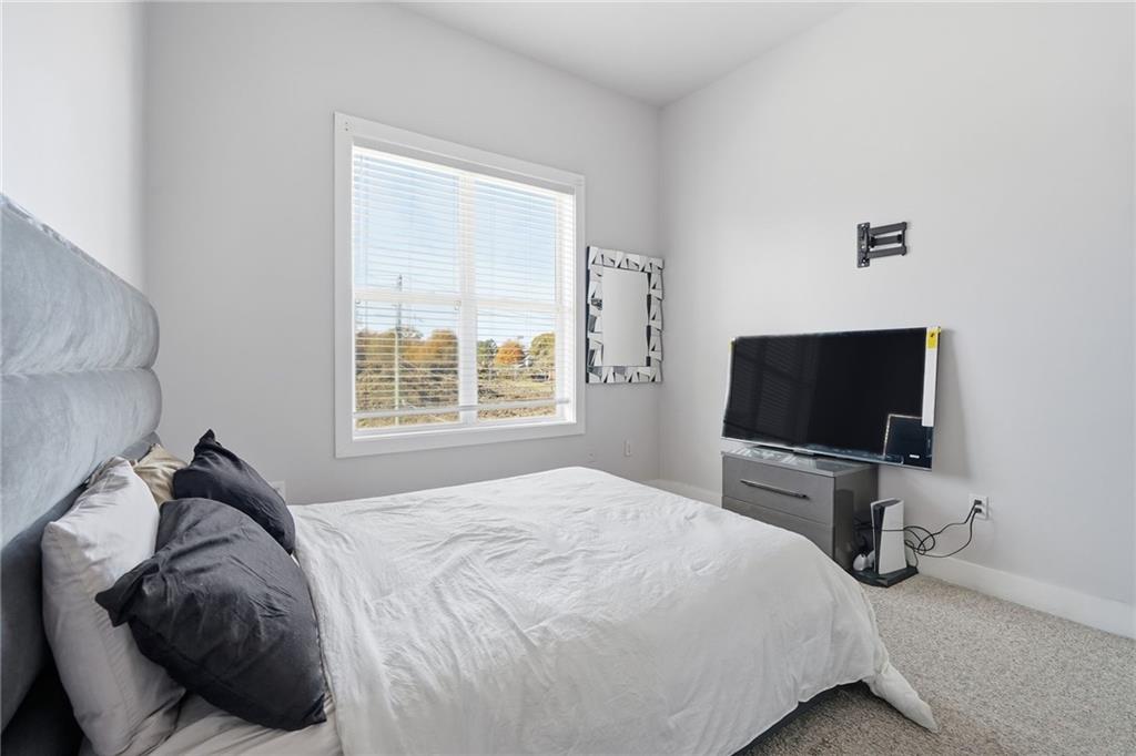 502 Pryor Street Southwest, Unit 328 Atlanta, GA 30312 - Photo 27 of 46 a bedroom with a bed and a flat screen tv