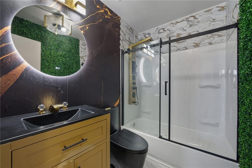 502 Pryor Street Southwest, Unit 328 Atlanta, GA 30312 - Photo 3 of 46 a bathroom with a sink toilet and shower