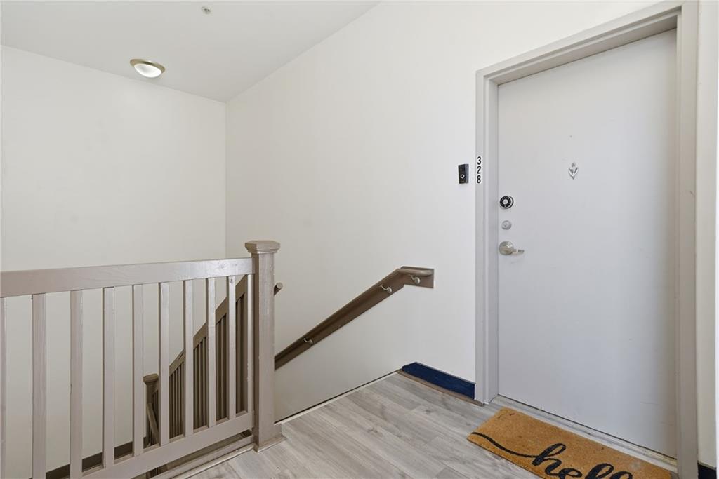 502 Pryor Street Southwest, Unit 328 Atlanta, GA 30312 - Photo 5 of 46 a view of a hallway with wooden floor