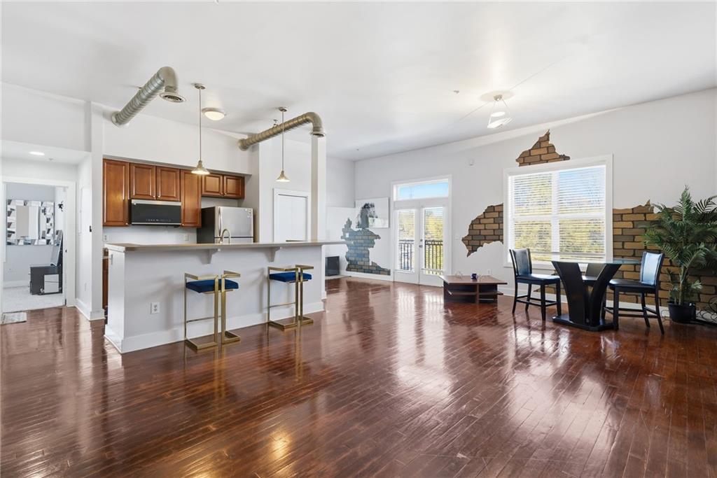 502 Pryor Street Southwest, Unit 328 Atlanta, GA 30312 - Photo 6 of 46 a living room with furniture kitchen view and a wooden floor