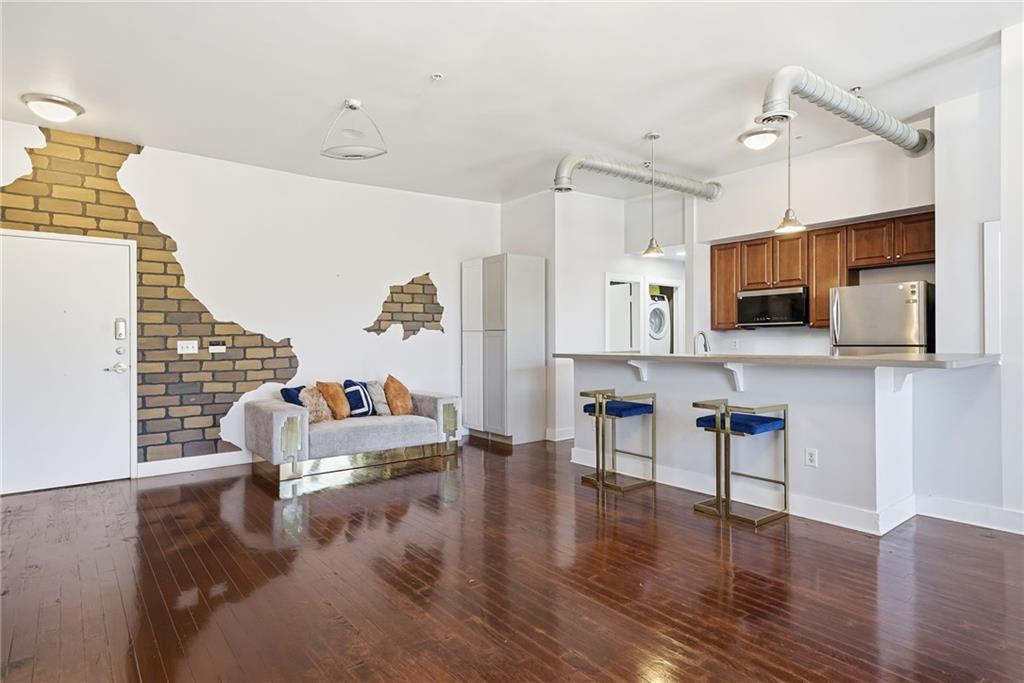 502 Pryor Street Southwest, Unit 328 Atlanta, GA 30312 - Photo 8 of 46 a living room with furniture wooden floor and kitchen view
