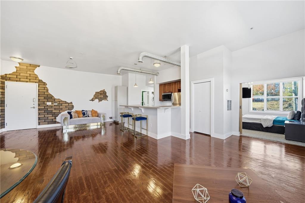 502 Pryor Street Southwest, Unit 328 Atlanta, GA 30312 - Photo 9 of 46 a living room with furniture and a wooden floor