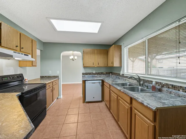 a kitchen with a sink stove and cabinets