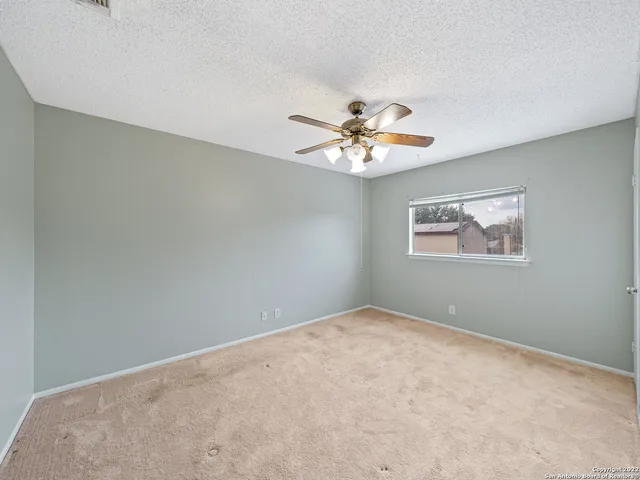 an empty room with wall painting and windows