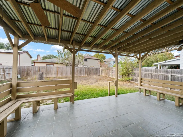 a view of a porch with furniture and a yard
