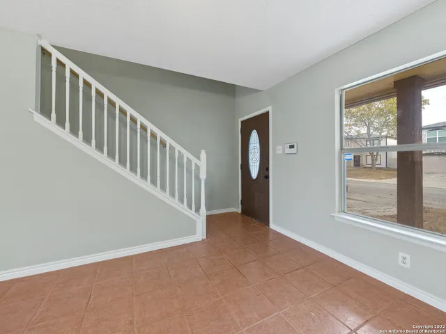 a view of an entryway with wooden floor