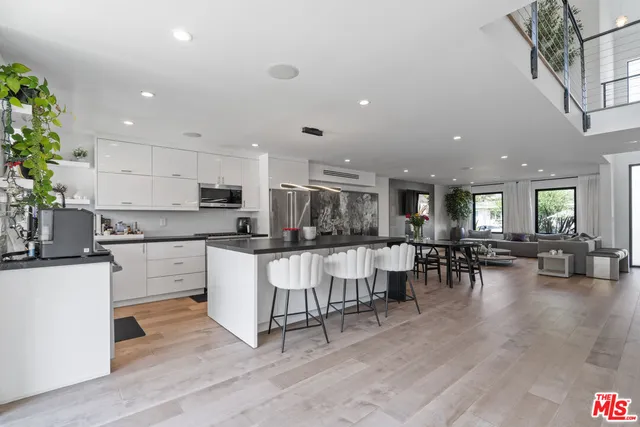 a kitchen with lots of counter top space and living room