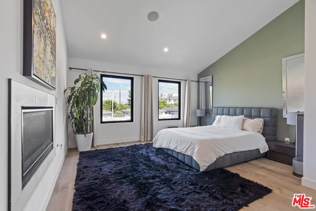 a spacious bedroom with a large bed and a window