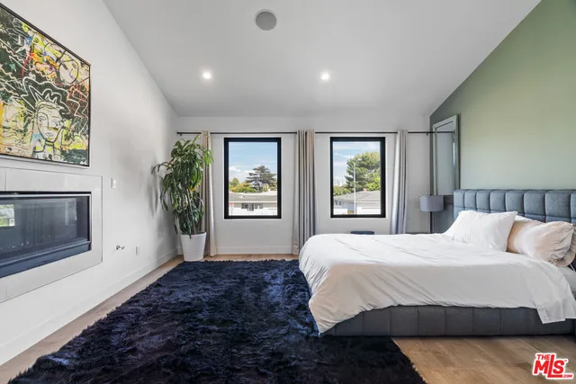 a bedroom with a large bed and a window