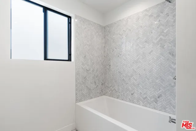 a white bath tub sitting next to a window