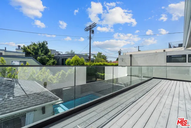 a view of a balcony with wooden floor