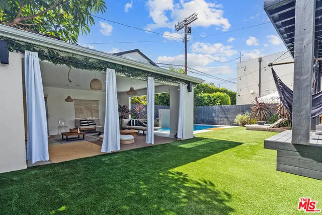 a living room with furniture a bed and a chandelier