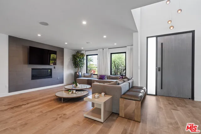 a living room with fireplace furniture and a flat screen tv