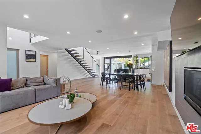 a living room with furniture and kitchen view