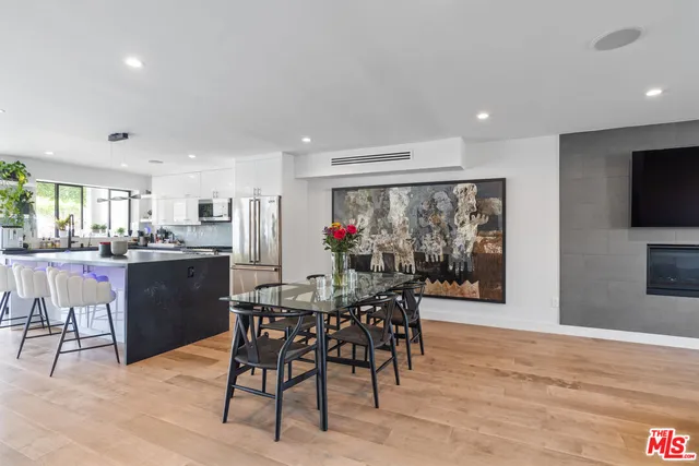 a dining room with furniture and wooden floor