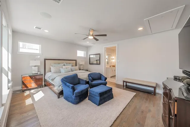 a bedroom with furniture and a wooden floor
