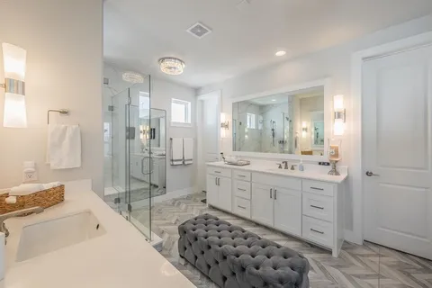 a spacious bathroom with a shower sink mirror and