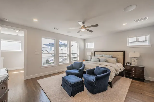 a spacious bedroom with a bed furniture and a window
