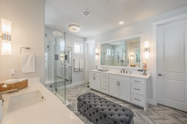 a spacious bathroom with a shower sink mirror and
