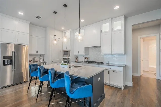 a large kitchen with a table and chairs