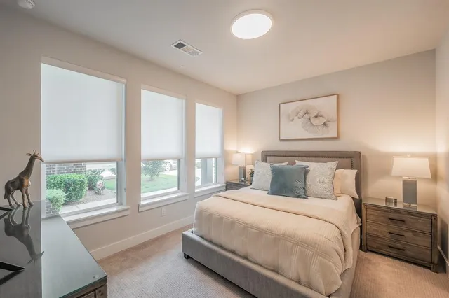 a bedroom with a large bed and a large window