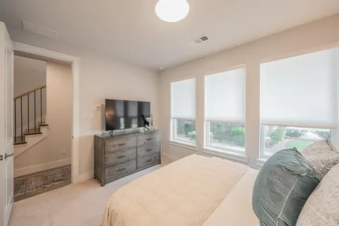 a bedroom with a bed and a television