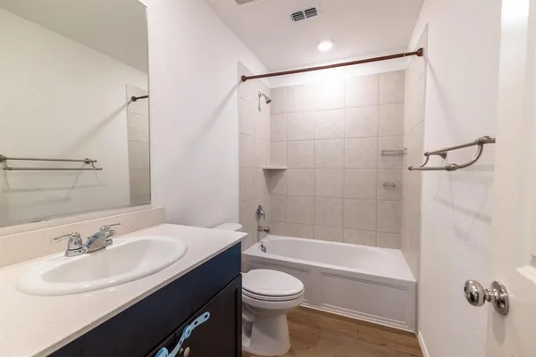 a bathroom with a sink toilet a mirror and shower