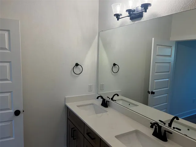a bathroom with a sink and mirror
