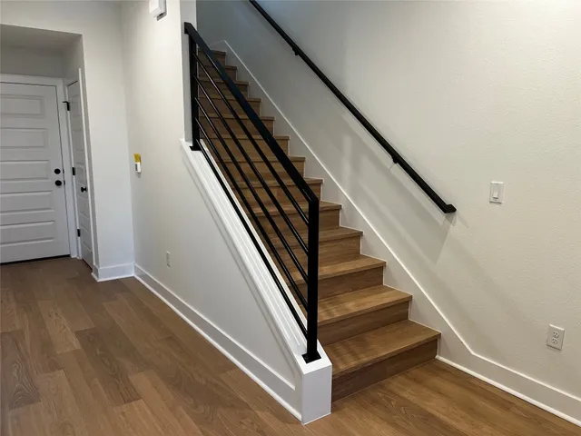 an entryway in a hallway with wooden floor