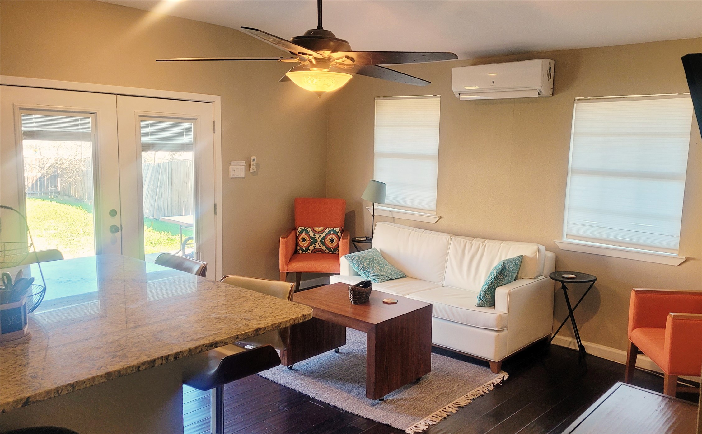 12410 Twin Creek Road Manchaca, TX 78652 - Photo 31 of 32 Living room featuring healthy amount of natural light, french doors, wood finished floors, and a ceiling fan