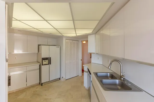 a kitchen with a sink cabinets and stainless steel appliances