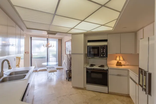 a kitchen with a refrigerator and a sink