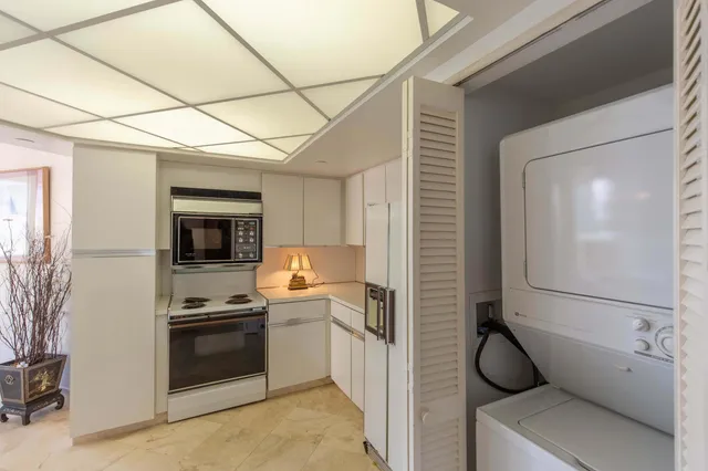 a living room with furniture a table and a large window