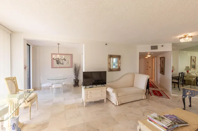 a view of a large room with wooden floor and outdoor view