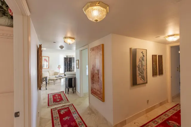 a very nice looking room with a large mirror and cabinets