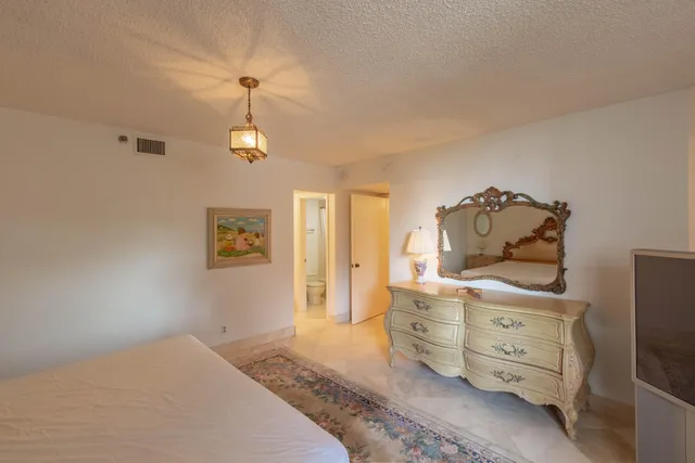 a bedroom with a bed and a tv