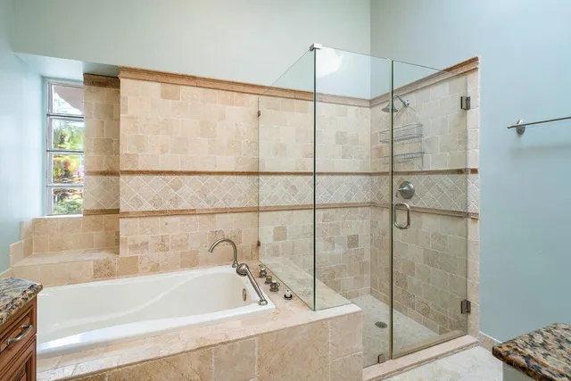 a bathroom with a bathtub and a shower