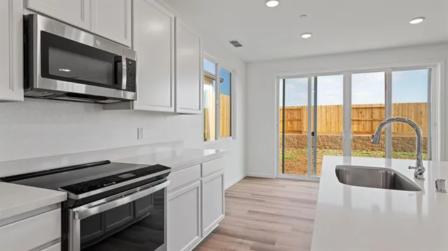 a kitchen with a large window and a sink