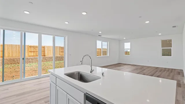 a kitchen with a sink and large window