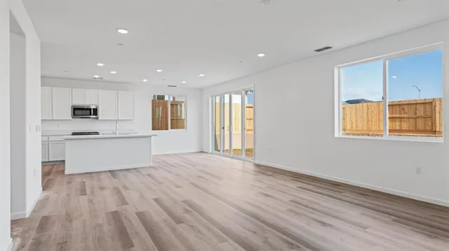 a large kitchen with stainless steel appliances granite countertop a stove and a refrigerator