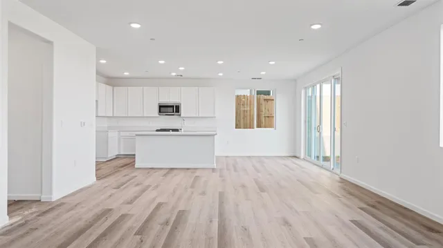 a view of kitchen with wooden floor and electronic appliances