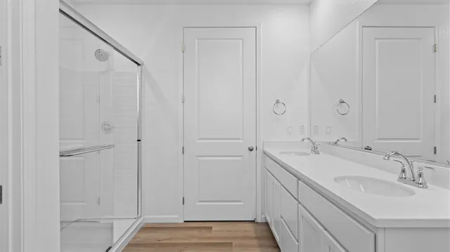 a bathroom with a double vanity sink and a mirror