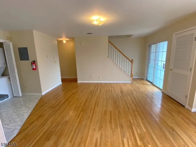 a view of a room with wooden floor and staircase