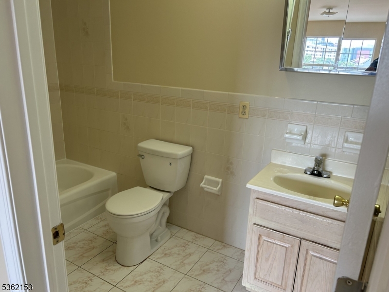 76 Union Street Newark, NJ 07105 - Photo 27 of 34 a bathroom with a sink toilet and window