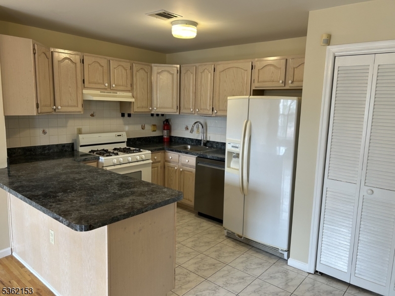 76 Union Street Newark, NJ 07105 - Photo 4 of 34 a kitchen with stainless steel appliances granite countertop a refrigerator sink and cabinets