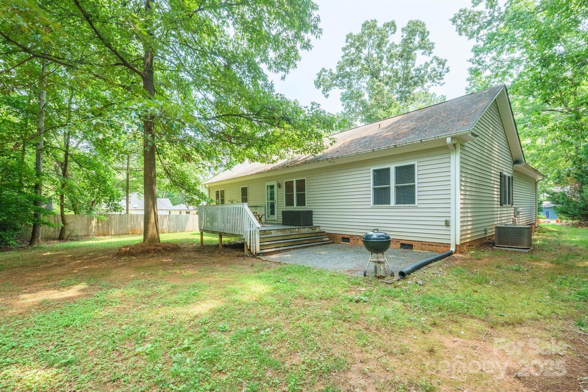 121 Jefferson Drive Locust, NC 28097 - Photo 21 of 22 a view of a yard with a house and a large tree